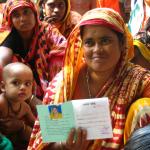 woman displaying her lending group membership card