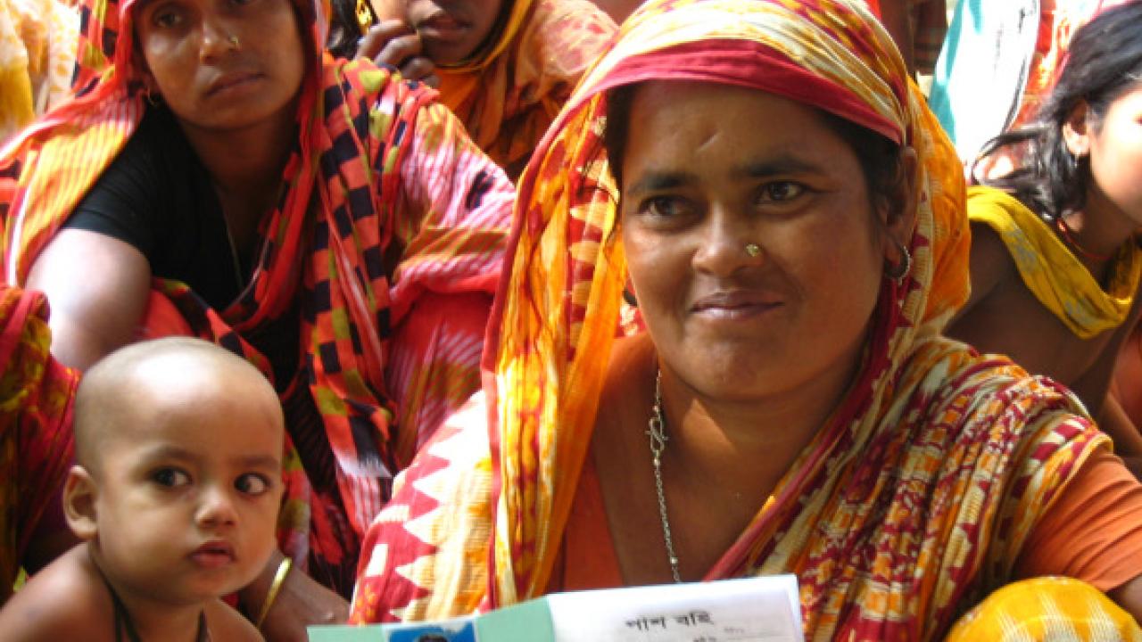woman displaying her lending group membership card